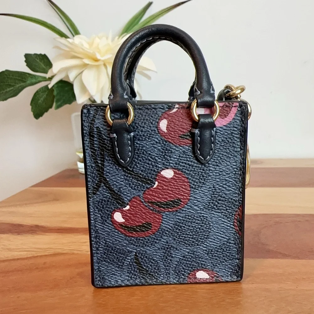NWT Coach North /South Mini Tote Bag Charm In Signature Canvas With Cherry Print